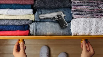 handgun atop jeans in a dresser drawer