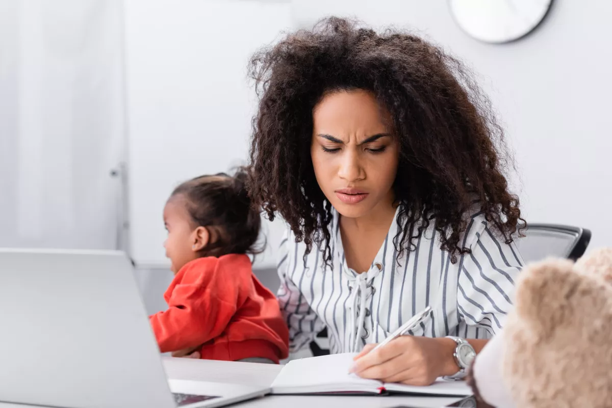 Young mom with toddler in front of laptop