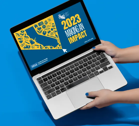 Image of laptop with front page of making an impact 2023 report