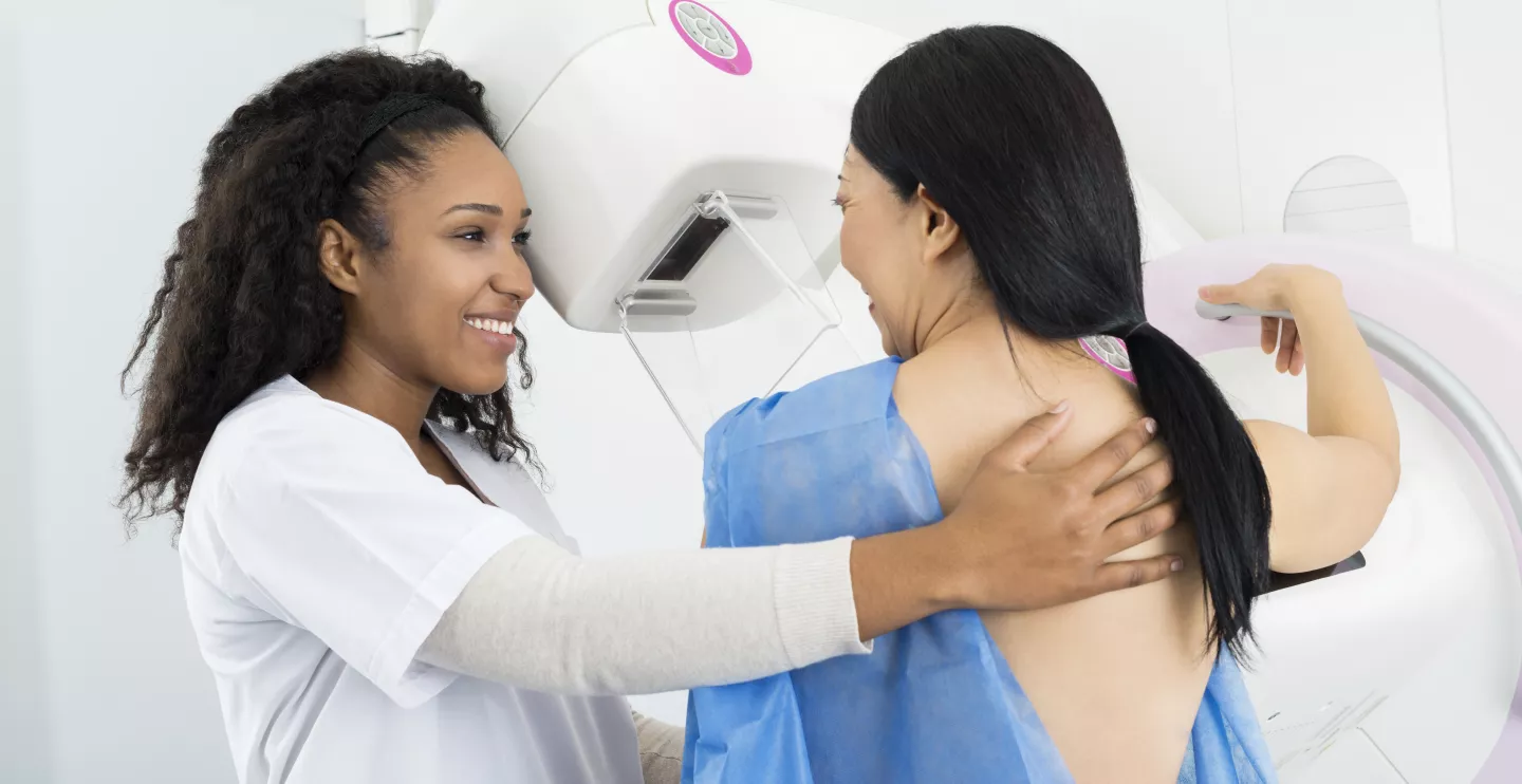 Nurse and patient near mammogram machine