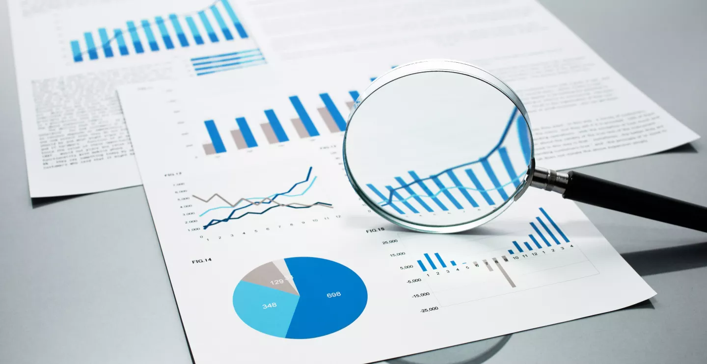 Photo of magnifying glass and data