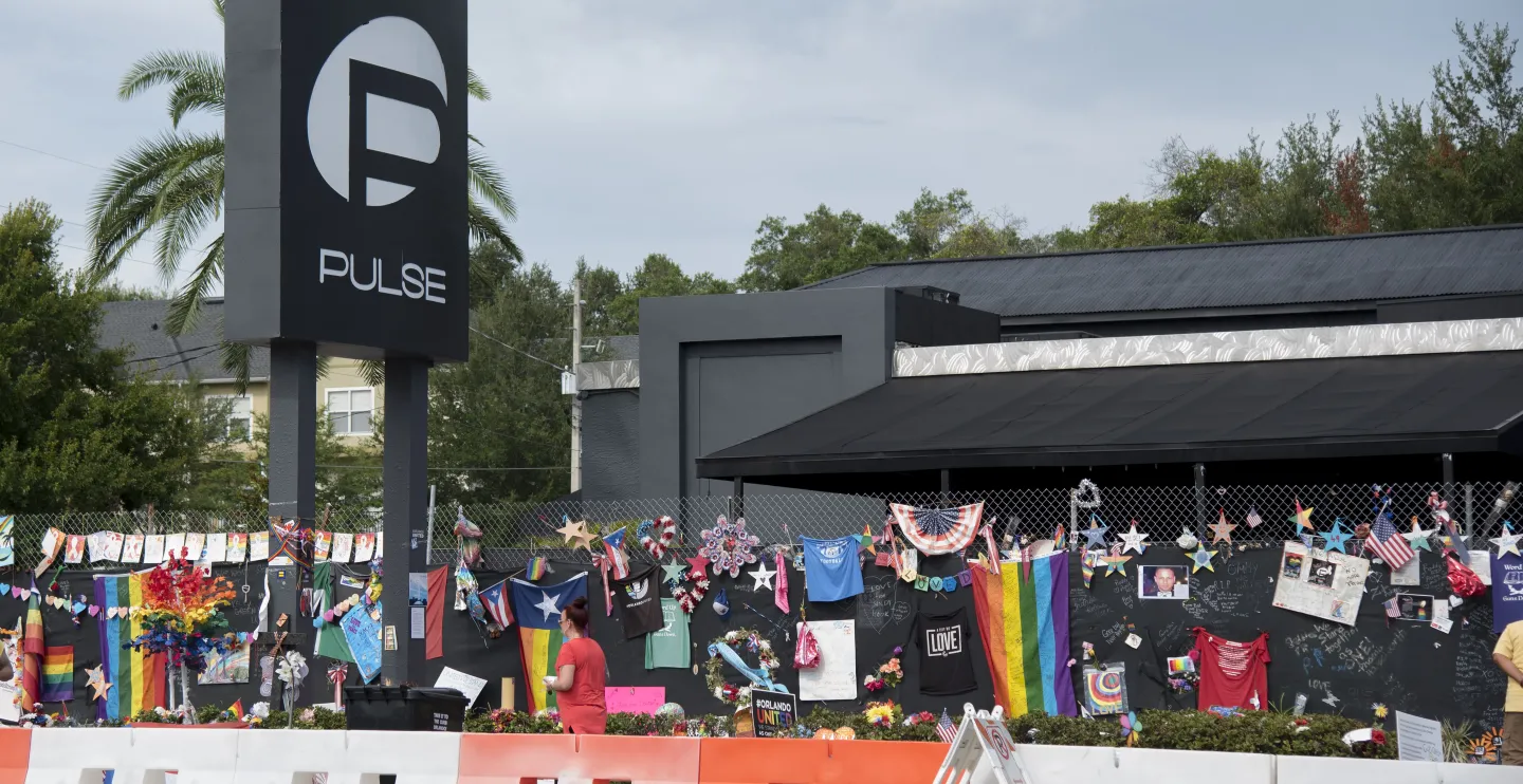 memorial with pride flags, photos, and testimonials honoring the victims of the Pulse nightclub shooting in Orlando