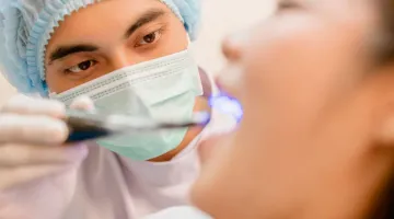 patient receiving dental care from hygienist