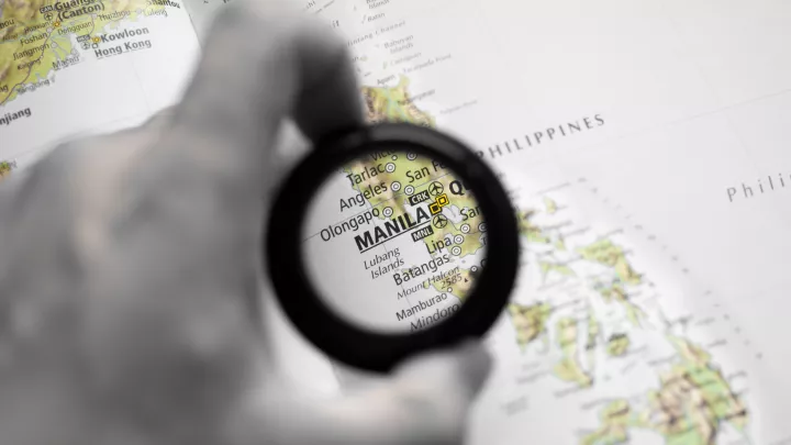 Map with magnifying glass focused on Manila