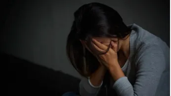 photo woman head in hands distressed