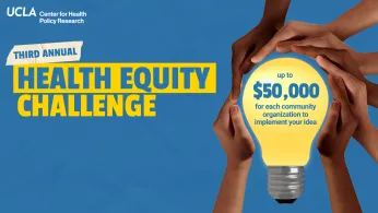 hands holding a lightbulb highlighting 50K prize for the Health Equity Challenge