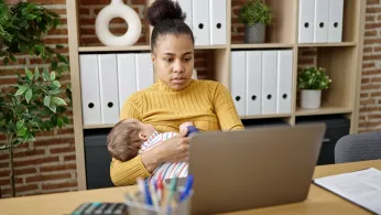 Woman breastfeeding while working